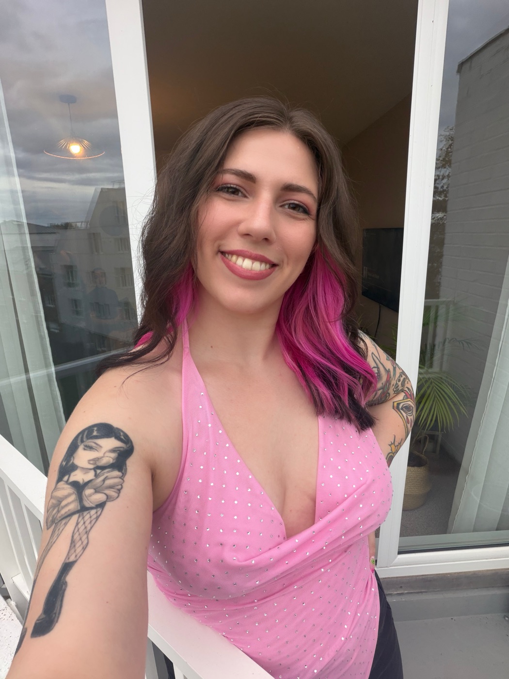 Amy Colin, smiling, on a balcony